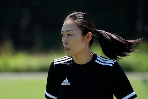 Japanese referee Yoshimi Yamashita warms up during a training session Monday, June 27, 2022, at JFA YUME Field in Chiba, near Tokyo. Yamashita is one three three women picked in a pool of 36 head referees for the men's World Cup in Qatar, which opens in just under five months on Nov. 21. It's the first time a female will be in charge on soccer largest stage. (AP Photo/Eugene Hoshiko)