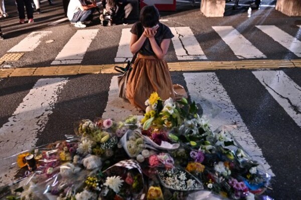 In Pictures | Woman Pays Tribute At Makeshift Memorial Outside Yamato-Saidaiji Station