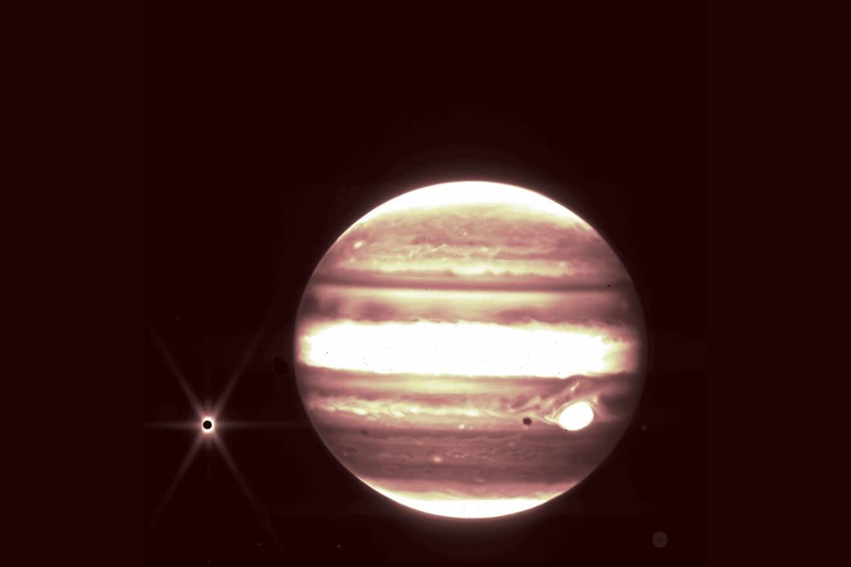 Jupiter, center, and its moon Europa, left, are seen through the James Webb Space Telescope’s NIRCam instrument 2.12 micron filter. (Image Credits: NASA, ESA, CSA, and B. Holler and J. Stansberry (STScI))