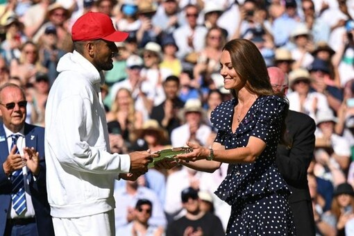 Nick Kyrgios receiving the Wimbledon trophy from the Duchess of Cambridge (Twitter)