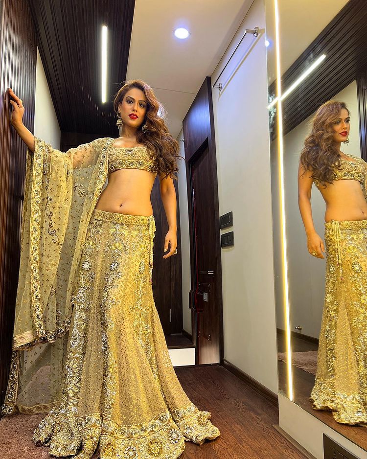 Nia Sharma looks gorgeous in the embellished golden lehenga. 