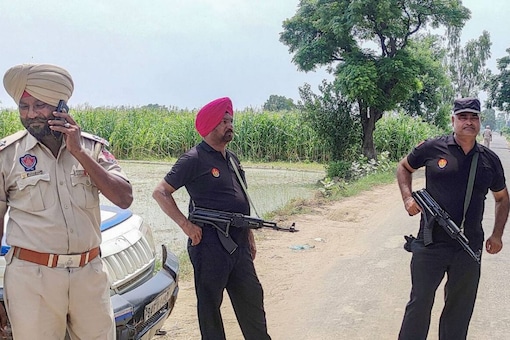 Punjab Police personnel during an encounter with gangsters suspected to be involved in the Sidhu Moose Wala murder case near Attari in Amritsar on July 20. (Image: PTI)