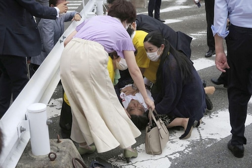 Former Japanese prime minister Shinzo Abe lies on the ground after being shot during an election campaign in Nara, western Japan, on Friday. (Reuters)