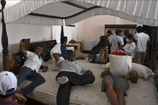 People crowd inside Sri Lanka's presidential palace in Colombo on July 10, a day after it was overrun by anti-government protestors. Sri Lanka's colonial-era presidential palace has embodied state authority for more than 200 years, but on July 10 it was the island's new symbol of people power after its occupant fled. (AFP)