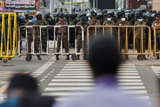 Security personnel stand guard next to a barricade near the Presidential Secretariat amid protests. (File/REUTERS/Adnan Abidi)