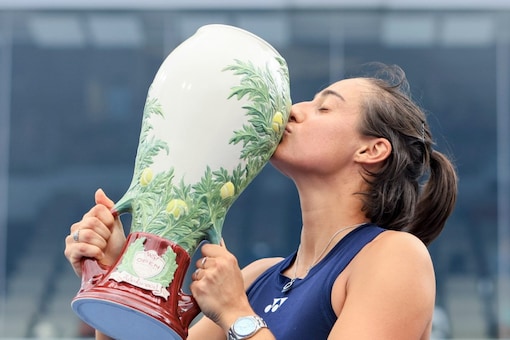 Caroline Garcia, of France, kisses the Rookwood Cup as she poses for photos after defeating Petra Kvitova, of the Czech Republic, during the women's singles final of the Western & Southern Open tennis tournament, Sunday, Aug. 21, 2022, in Mason, Ohio. (AP Photo/Aaron Doster)