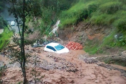 Chamba: A vehicle stuck in debris following a cloudburst, triggered by incessant monsoon rains, in Himachal Pradesh's Chamba district, Monday, Aug. 8, 2022. (PTI Photo)