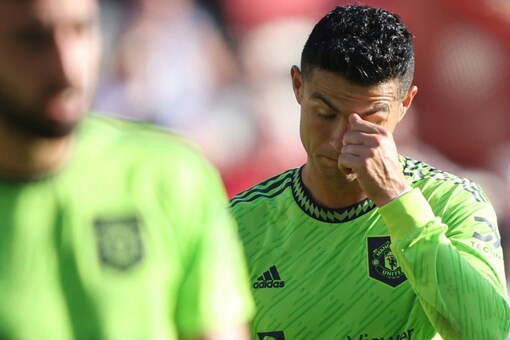 Manchester United's Cristiano Ronaldo right reacts as his team lose another goal to Brentford during the English Premier League soccer match between Brentford and Manchester United at the Gtech Community Stadium in London, Saturday, Aug. 13, 2022. (AP Photo/Ian Walton)