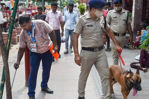 Bomb Detection and Disposal Squad personnel with a sniffer dog inspect near the Red Fort in New Delhi on Sunday. (Photo: PTI)