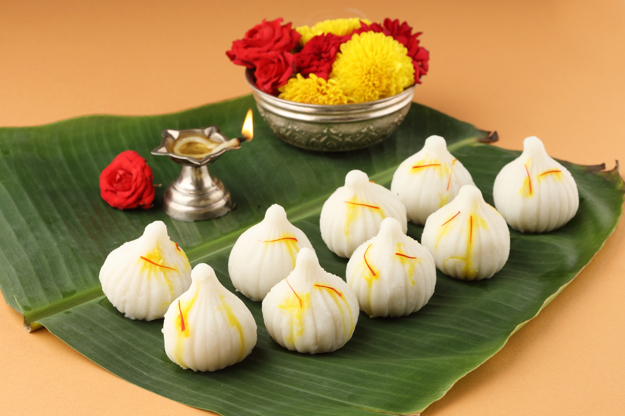 MODAK: The delicious sweet is considered to be Ganpatis most favourite. He is often called Modakpriya for his love for modaks. This sweet would be the best to offer to Ganesha on the first day of th auspicious occasion. The modak bhog can be made in different varieties to please the diety - steamed modak, chocolate modak, fried modak, among others. (Representative image: Shutterstock)