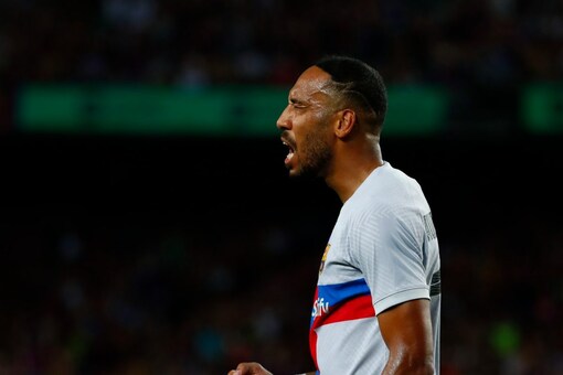 Barcelona's Pierre-Emerick Aubameyang celebrates after scoring his side's opening goal during a charity friendly soccer match between Barcelona and Manchester City at the Camp Nou stadium in Barcelona, Spain, Wednesday, Aug. 24, 2022. (AP Photo/Joan Monfort)
