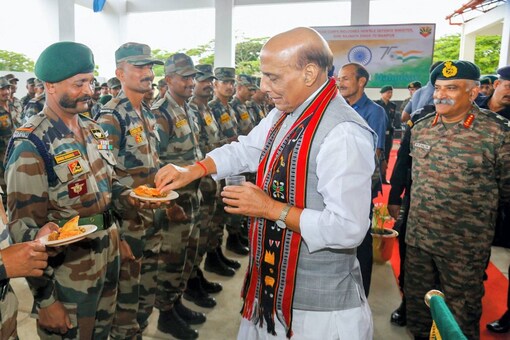 Defence Minister Rajnath Singh with troops of Red Shield Division and Assam Rifles during his visit to Headquarters Inspector General Assam Rifles (South) at Mantripukhri in Imphal. (PTI)