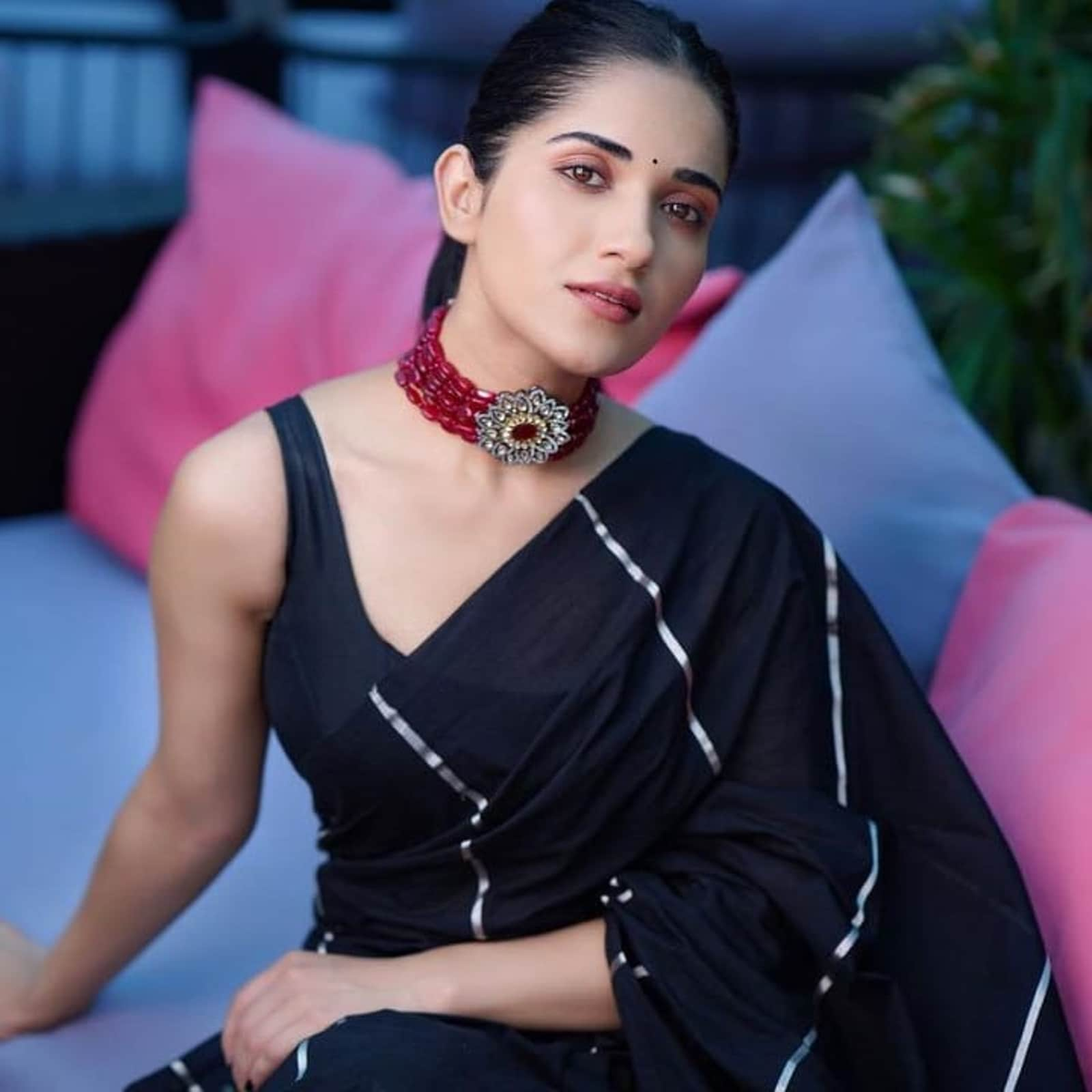 Actor Ruhani Sharma drapes a black kasavu featuring silver stripes.