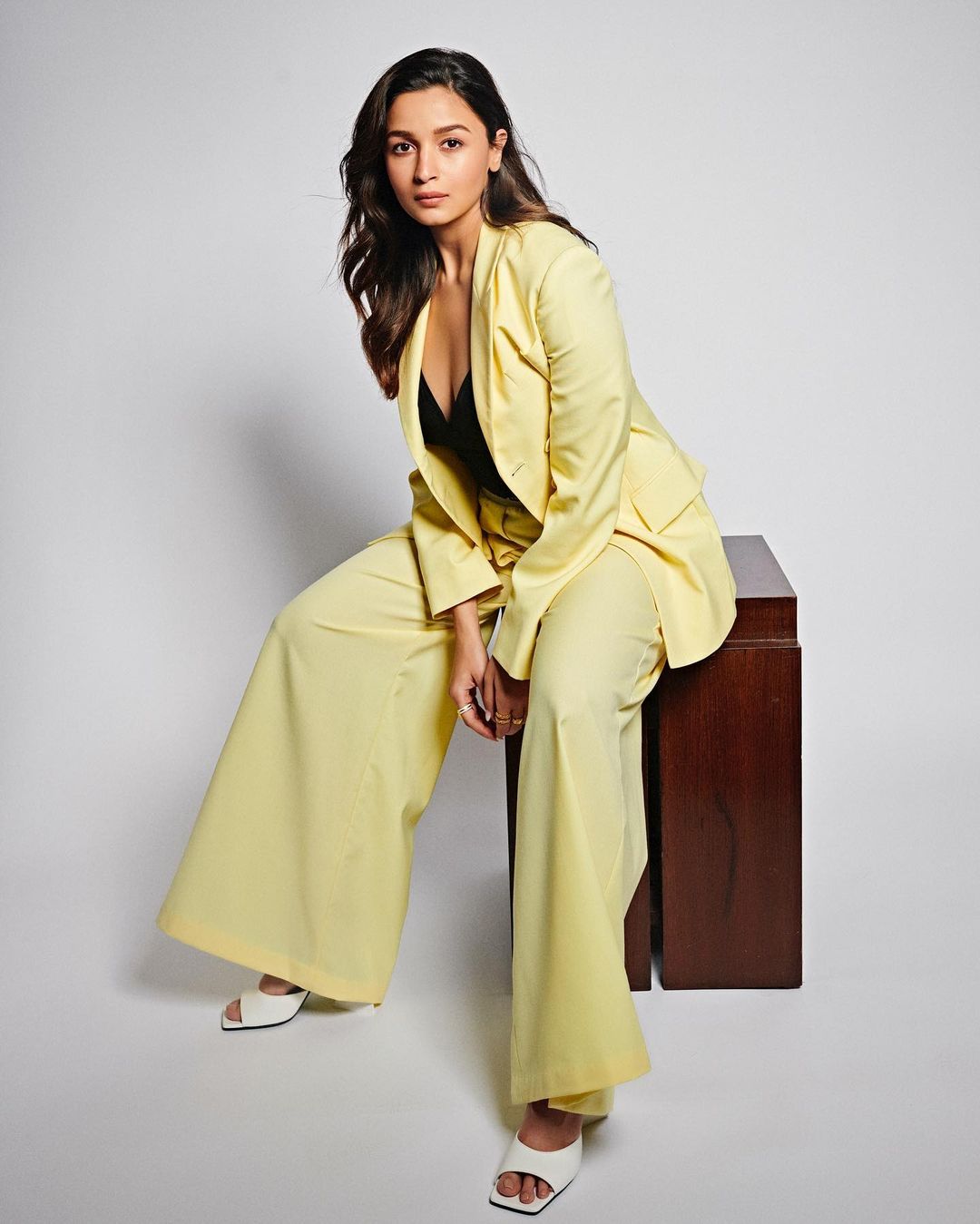 Alia Bhatt looks smart in a pale yellow pantsuit.