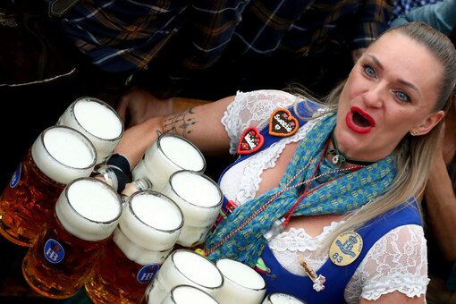 A waitress holds twelve glasses of beer during the opening of the 186th 'Oktoberfest' beer festival in Munich, Germany (Image: AP File)