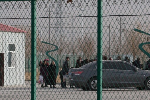 Residents line up inside the Artux City Vocational Skills Education Training Service Center which has previously been revealed by leaked documents to be a forced indoctrination camp at the Kunshan Industrial Park in Artux in western China's Xinjiang region. (Image: AP file)