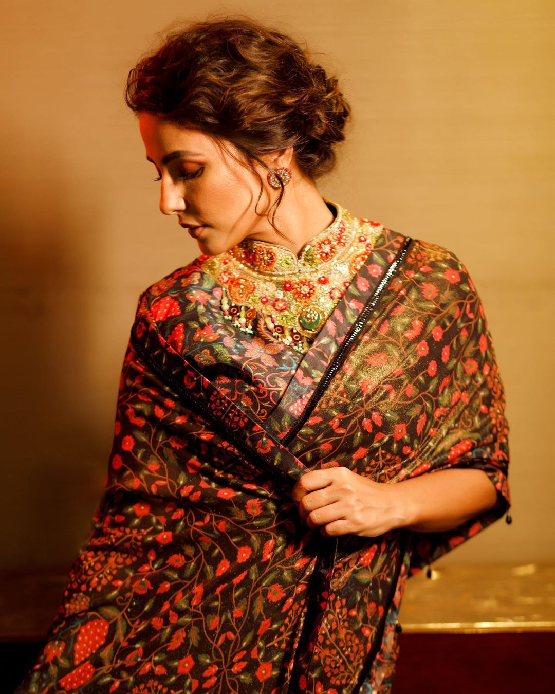 Hina Khan pairs the saree with a matching floral blouse.
