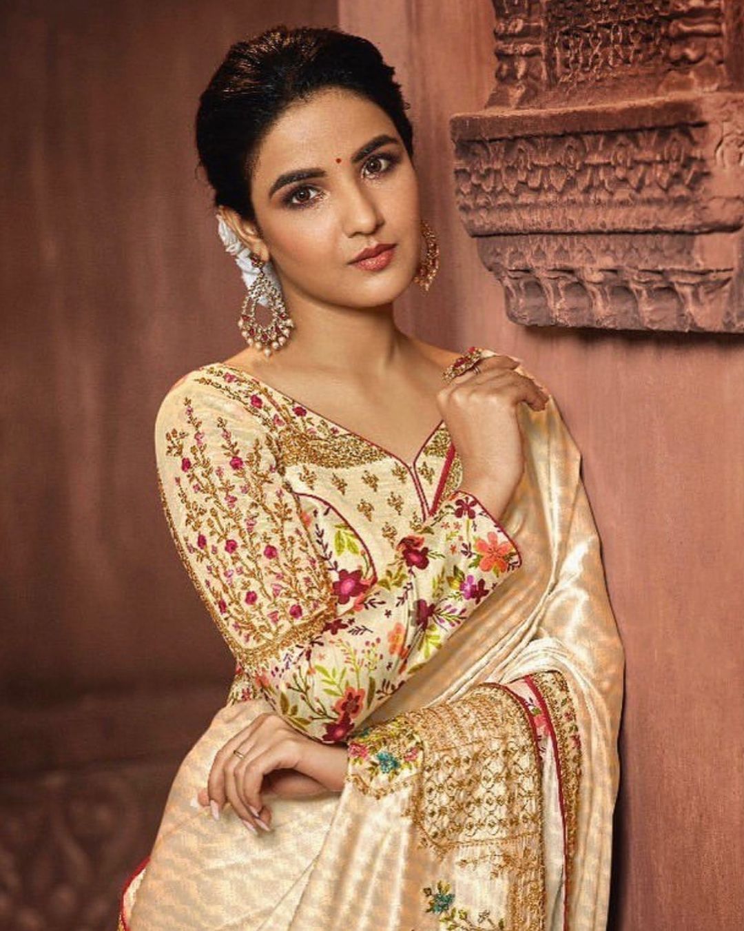Jasmin Bhasin looks graceful in the golden saree with a floral blouse.