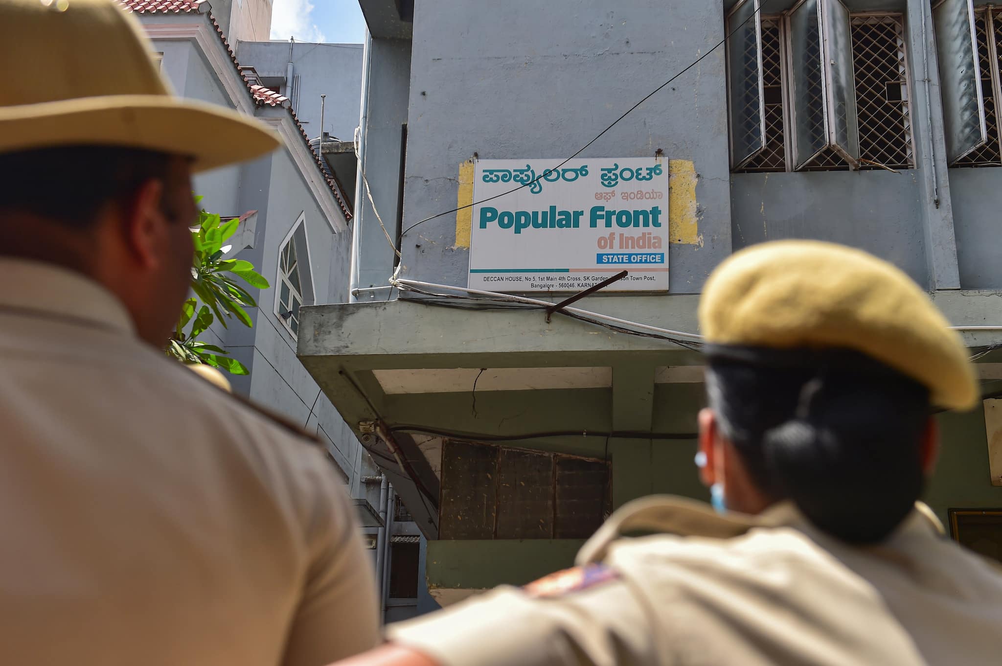 Security personnel keep vigil outside the Popular Front of India (PFI) party office in Bengaluru on Thursday. (PTI)