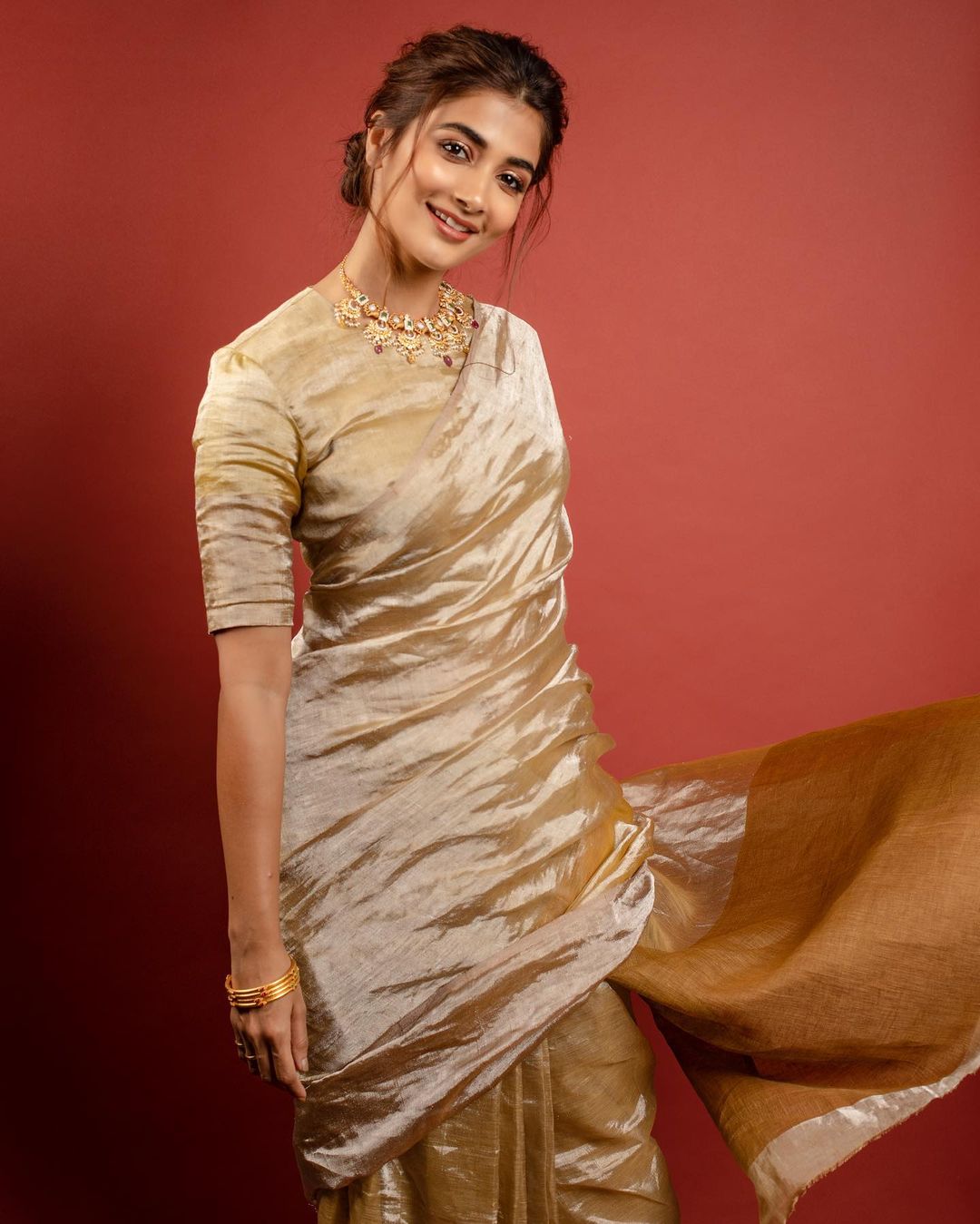 Pooja Hegde looks graceful in the golden saree. 