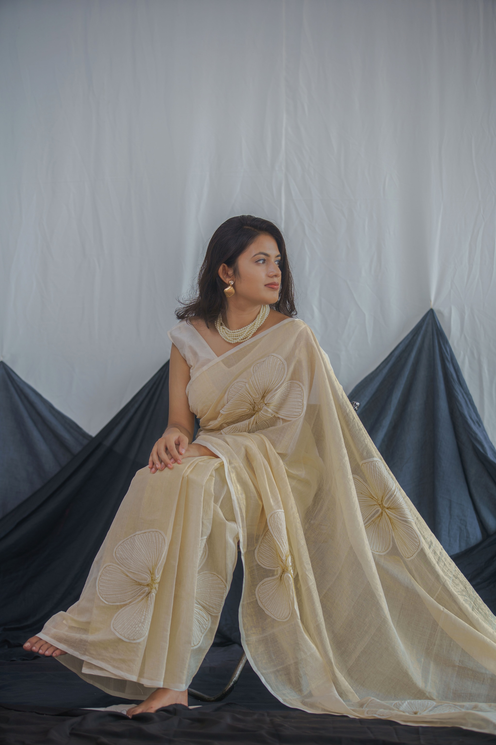 A contemporary version of the classic ivory and gold sari with applique work.