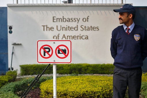 A private security guard stands outside the US embassy in New Delhi. Indians wanting to study and visit the US are worried about long wait times stretching up to 2025 (Image: Reuters File)