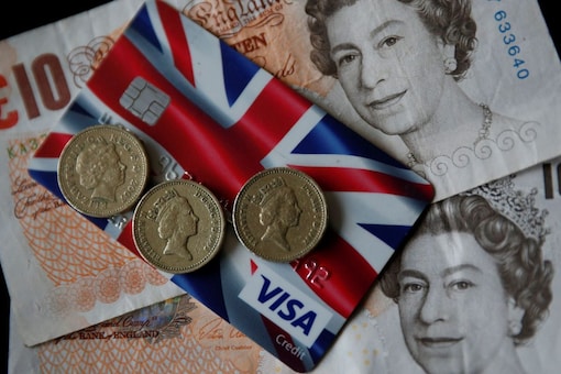 A Union Jack themed Visa credit card is seen amongst British currency in this photo illustration taken in Manchester, Britain March 13, 2017. Reuters