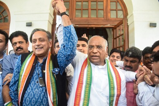 Shashi Tharoor greets newly elected Congress President Mallikarjun Kharge at the latter's residence, in New Delhi, Wednesday.