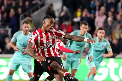 Brentford's Ivan Toney scores against Brighton and Hove Albion during the English Premier League soccer match at the Gtech Community Stadium, London, Friday Oct. 14, 2022. (John Walton/PA via AP)