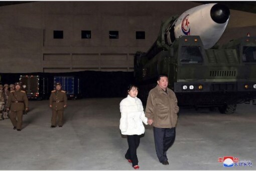 This picture released from North Korea's official Korean Central News Agency shows North Korea's leader Kim Jong Un walking with his daughter as he inspects a new intercontinental ballistic missile (ICBM) ahead of its launch at Pyongyang International Airport. (AFP)