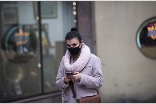 A woman wear a mask as she walks along a street in Skopje on January 30, 2019, one of the most polluted cities in Europe. (AFP)