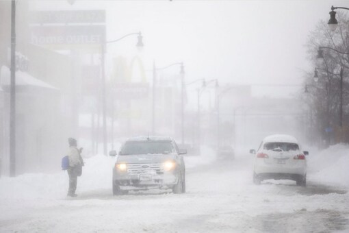 A person tries to cross a street during a snow storm hitting the Buffalo area in Buffalo, New York, U.S. November 19, 2022 REUTERS/Carlos Osorio. (Reuters)