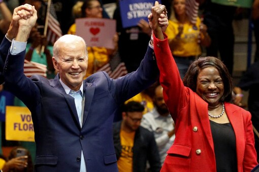 US President Joe Biden holds hands with Democratic Party's senatorial candidate Val Demings during a campaign rally in Miami, Florida (Image: Reuters)