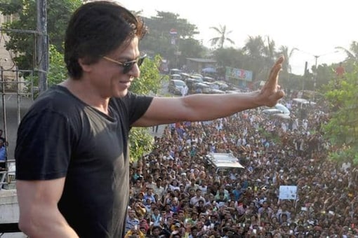 Shah Rukh Khan waves at his fans from his mansion, Mannat.