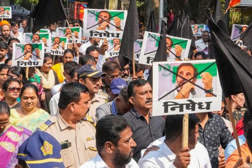 Shiv Sena Shinde faction members during a protest against Congress leader Rahul Gandhi over his alleged controversial remarks on Hindutva ideologue VD Savarkar, in Mumbai. (Image: PTI/Shashank Parade)