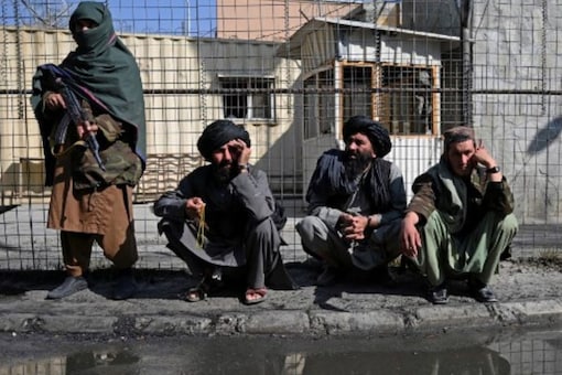 Taliban fighters stand guard at an entrance gate of the Sardar Mohammad Dawood Khan military hospital in Kabul on November 3, 2021, a day after an attack claimed by the Taliban's hardline rivals the Islamic State-Khorasan (IS-K), in which at least 19 people were killed. (AFP)