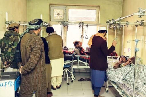 Wounded Afghan men receive treatment at a hospital following a blast at a madrassa in Aybak city of Samangan province (AFP Photo)