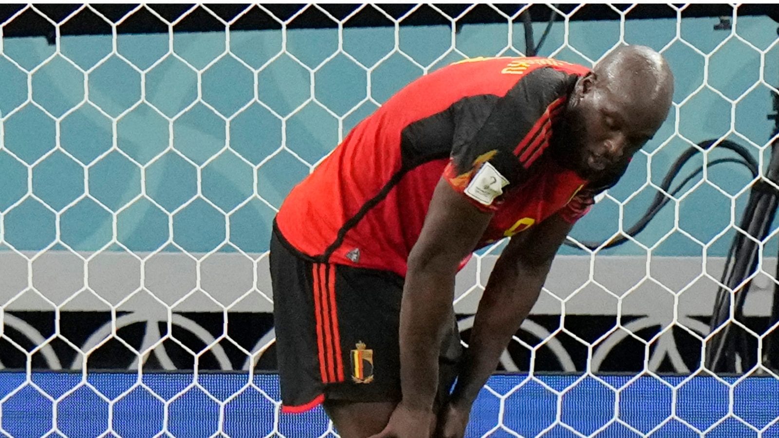 De Belg Timothy Castagne verdedigt Romelu Lukaku na uitschakeling aan het begin van het WK