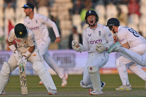 England's Joe Root, left, Ollie Pope, center and their teammates celebrate after the dismissal of Pakistan's Imam-ul-Haq, left, during the third day of the second Test (AP Image)