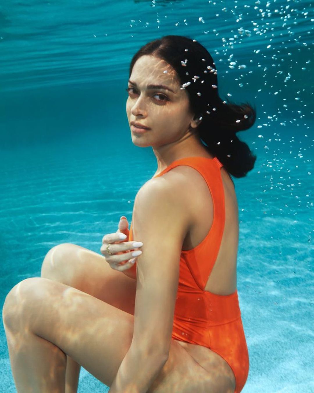 Deepika posed underwater in a bright orange swimsuit for the promotions of Gehraiyaan. (Image: Instagram)