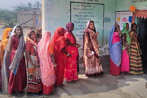 Amreli: Women wait in a queue to cast their votes during the first phase of Gujarat Assembly elections, at Shiyalbet village in Amreli district, Thursday, Dec. 1, 2022. Shiyalbet, surrounded by Arabian Sea, is reachable only by boat. Five polling stations have been set up in the island. (PTI Photo)