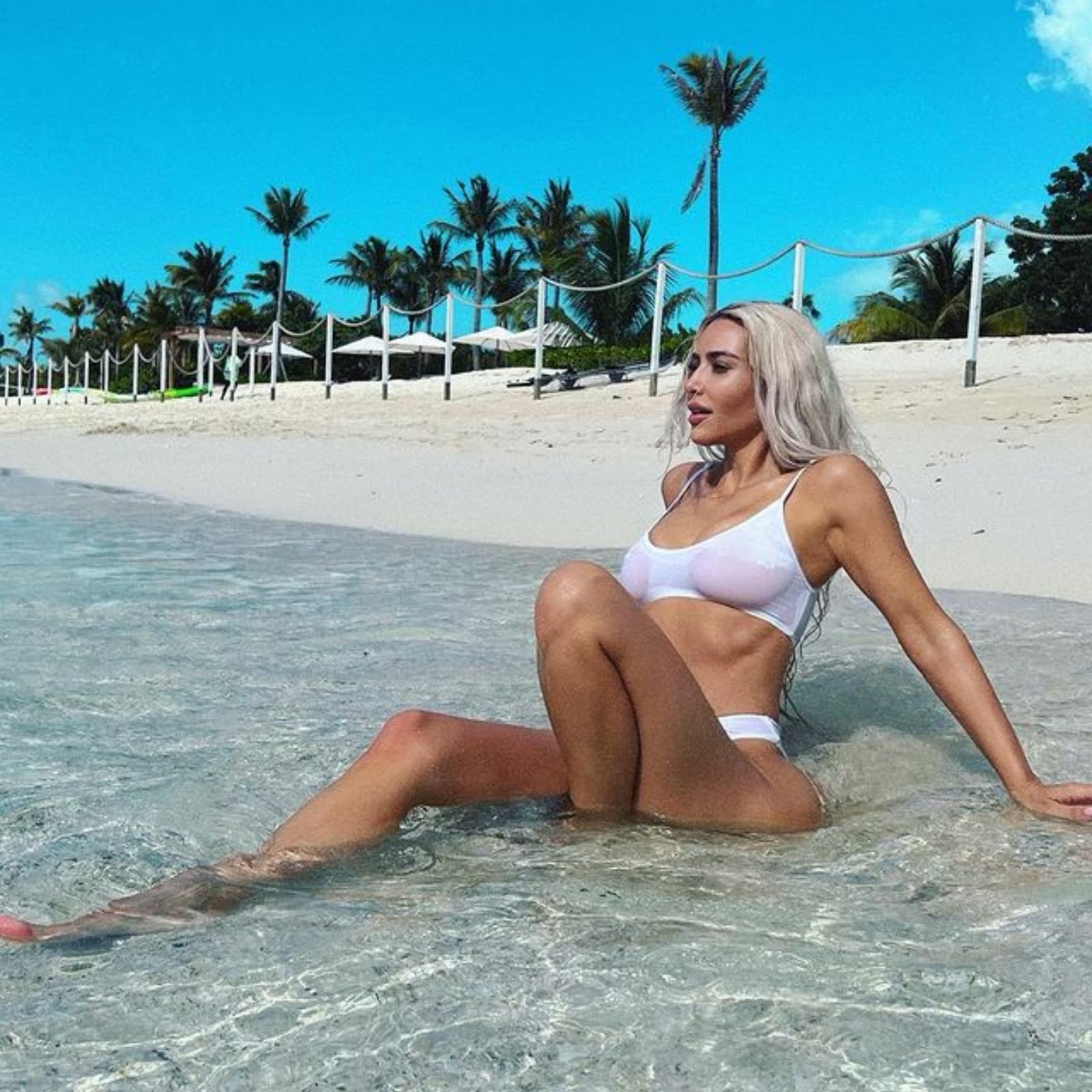 Kim Kardashian takes off her bikini bottoms while posing in a