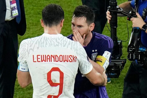 Robert Lewandowski interacts with Argentina's Lionel Messi. (AP Photo)