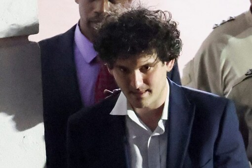 Sam Bankman-Fried, who founded FTX until a liquidity crunch forced the cryptocurrency exchange to declare bankruptcy, is escorted out of the Magistrate Court building after his arrest, in Nassau, Bahamas (Image: Reuters)