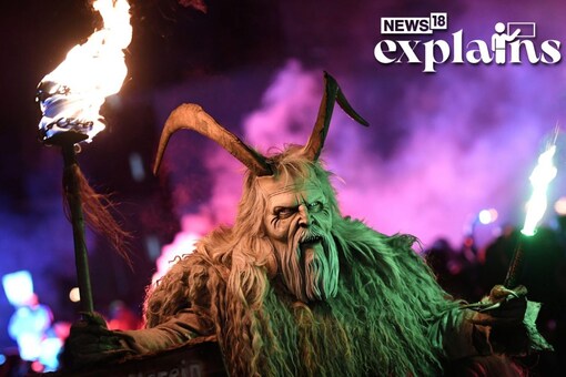 A participant wearing a traditional Krampus costume and a mask performs during a Krampus run in the village of Biberwier, Austria November 30, 2019. REUTERS/Angelika Warmuth
