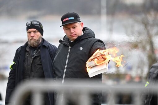 Leader of the far-right Danish political party Stram Kurs Rasmus Paludan burns a copy of the Koran during a manifestation outside the Turkish embassy in Stockholm, Sweden. (Reuters)