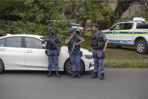 South African Police Service stand near a roadblock to fight the high level of criminality in Johannesburg on November 24, 2022. (AFP)