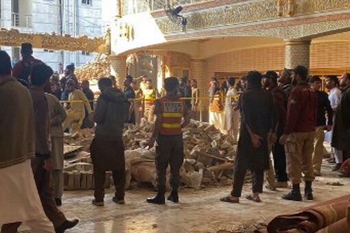 Pakistan Peshawar Mosque Bomb Blast: Cops and residents rescue those trapped in the debris inside a mosque in Peshawar, following a bomb blast (Image: AFP)