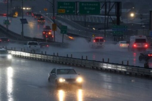 Cars drive along highway as rain falls on January 4 in Greenbrae in California. (Image: AFP)