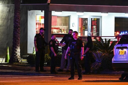 Miami Gardens Police officers walk out of the “The Licking” restaurant in Miami Gardens, Florida, on January 5, 2023. Multiple people were shot Thursday night outside of a Miami Gardens restaurant during a video shoot for rappers French Montana and Rob49. (Image: AFP)